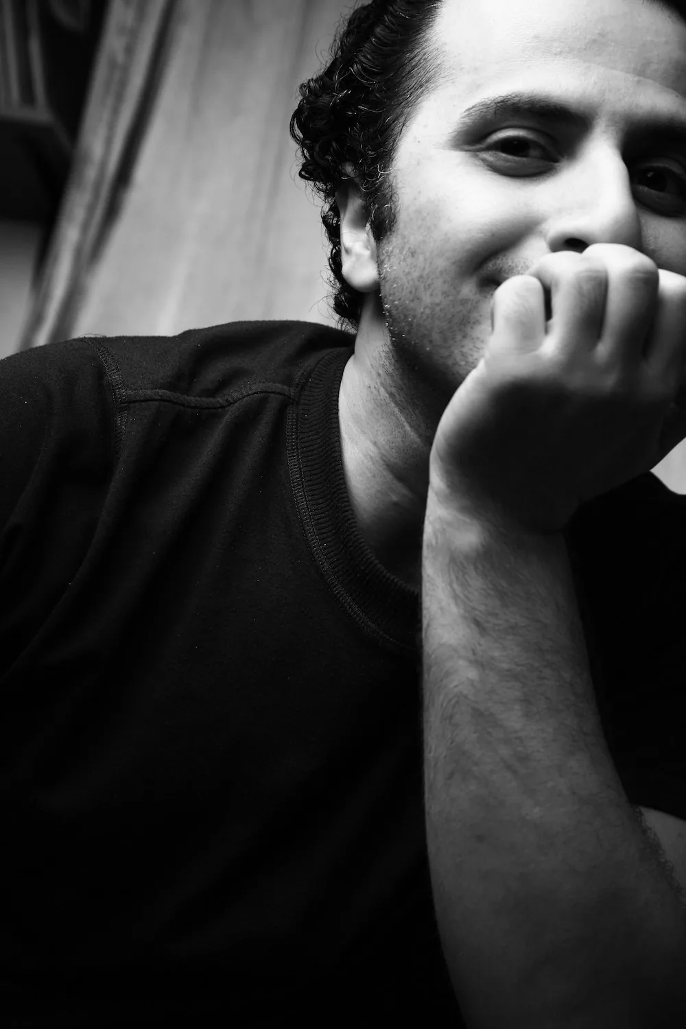 Portrait of Mehrdad Khataei resting his chin on his hand